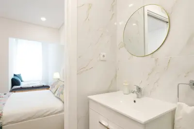 a bathroom with a sink and a mirror at VIVA Spacious Apartment Campanhã in Porto