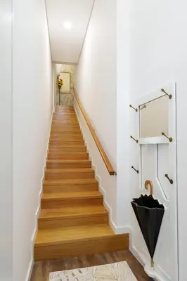 a hallway with stairs with an umbrella at VIVA Spacious Apartment Campanhã in Porto