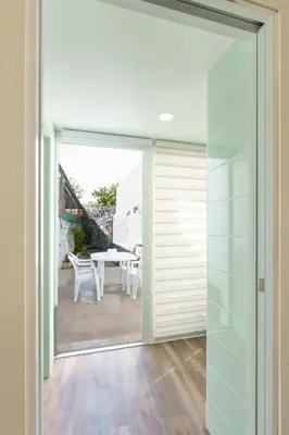 a sliding glass door leading to a patio with a table at VIVA Spacious Apartment Campanhã in Porto