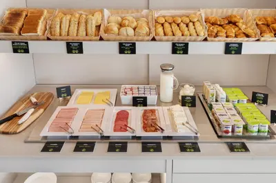 a bakery counter with different types of bread and pastries at B&B HOTEL Porto Centro Massarelos in Porto