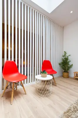 a bed with pillows and a mirror on the wall at 100 Contos in Porto