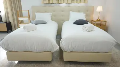 two beds with white sheets and pillows in a room at Ryamen Inn B in Porto
