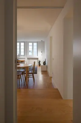 a dining room and living room with a table and chairs at Santa Catarina 555 T4 in Porto