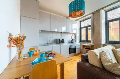 a living room with a table and a kitchen at Groovy Porto by Upperground in Porto