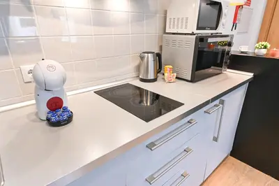 a kitchen with a robot on a counter with a microwave at Boavista Residence T3 in Porto