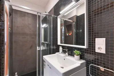 a bathroom with a sink and a glass shower at Boavista Residence T3 in Porto