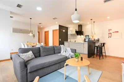 a living room with a couch and a table at Boavista Residence T3 in Porto