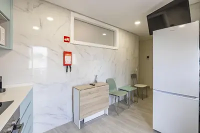 a room with white marble walls and a desk and chairs at D&S - Torne 187 in Vila Nova de Gaia
