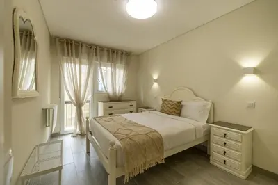 a white bedroom with a bed and a window at D&S - Torne 187 in Vila Nova de Gaia