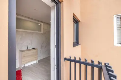 a door leading into a room with a stone wall at D&S - Torne 187 in Vila Nova de Gaia