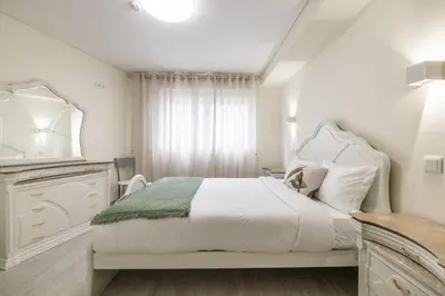 a white bedroom with a large bed and a dresser at D&S - Torne 187 in Vila Nova de Gaia