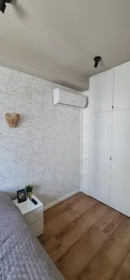 a bedroom with a bed and a white wall at Cantinho da Boavista in Porto