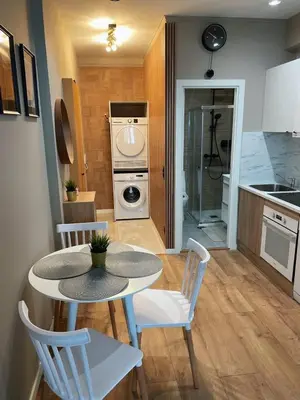 a kitchen with a table and chairs and a kitchen with a stove at Cantinho da Boavista in Porto
