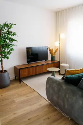 a living room with a couch and a flat screen tv at Lighthouse by MyMoradia I Vue & Élégance à Porto in Porto