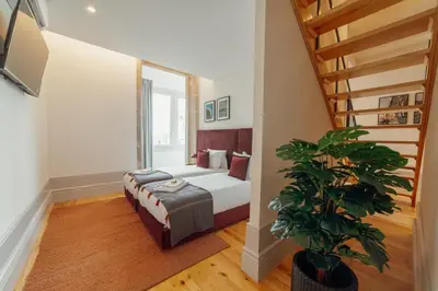 a bedroom with a bed and a potted plant at Heart of Porto Apartments by Vacationy in Porto