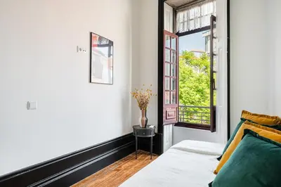 a bedroom with a bed and a window at Terraced Apartment in the Heart of Porto - Free Parking in Porto