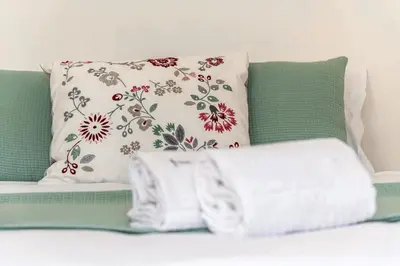 a couch with two pillows and a towel at Porto Inlapa Studio RC in Porto