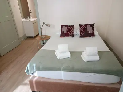 a bedroom with a large bed with two pillows at Porto Inlapa Studio RC in Porto