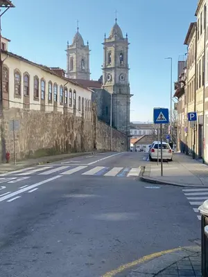 an empty street with a building and a clock tower at Porto Inlapa Studio RC in Porto