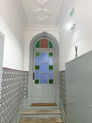 a white door with a colorful window in a room at Porto Inlapa Studio RC in Porto