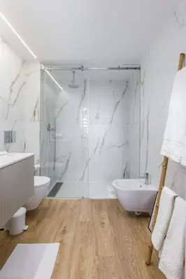 a bathroom with a shower and a toilet and a sink at Douro Tower Loft - Shared Pool in Vila Nova de Gaia