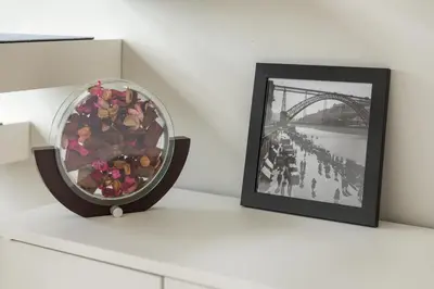 a bowl of flowers on a shelf next to a picture at Douro Tower Loft - Shared Pool in Vila Nova de Gaia
