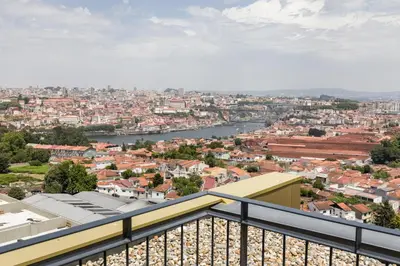 a view of a city from a balcony at Douro Tower Loft - Shared Pool in Vila Nova de Gaia