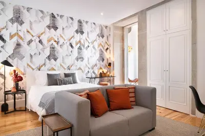 a bedroom with a large bed and a couch at Private Terrace at Flores Street in Porto