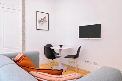 a living room with a couch and a table at Private Terrace at Flores Street in Porto
