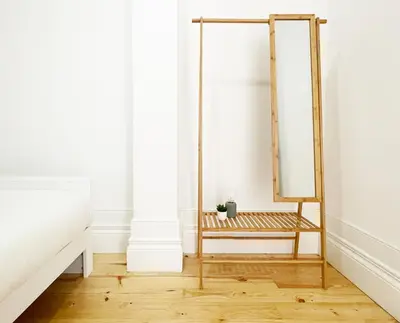 a dressing room with a mirror and a chair at MariPinto Downtown Apartment in Porto