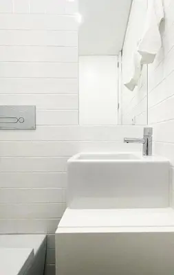 a white bathroom with a sink and a mirror at MariPinto Downtown Apartment in Porto
