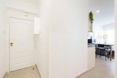 a white bathroom with a shower and a toilet at VIVA Elias Sunset Apartment Gaia in Vila Nova de Gaia