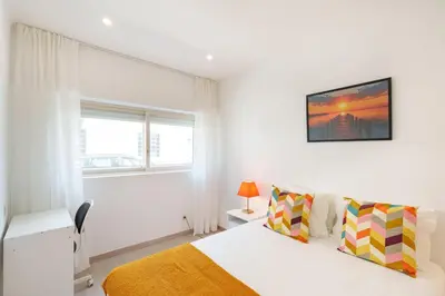 a living room with a couch and a window at VIVA Elias Sunset Apartment Gaia in Vila Nova de Gaia