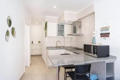 a white bedroom with a bed and a window at VIVA Elias Sunset Apartment Gaia in Vila Nova de Gaia