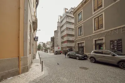 two cars parked on a city street with buildings at Downtown Gold Bolhao by Vacationy in Porto