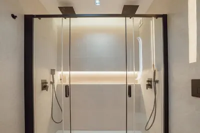 a shower with a glass door in a bathroom at Downtown Premium With Balcony by Vacationy in Porto