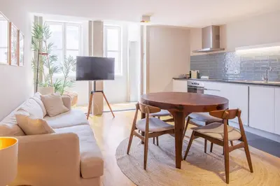 a living room with a table and a couch at Almada 151 - 3T in Porto