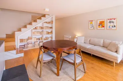 a living room with a table and a couch at Almada 151 - 3T in Porto