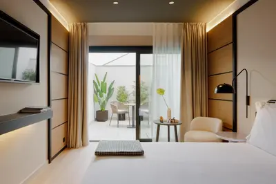 a hotel room with a bed and a view of a patio at Porto River Soul Hotel in Vila Nova de Gaia