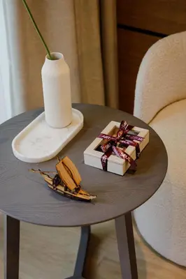 a table with a plate of food and a vase at Porto River Soul Hotel in Vila Nova de Gaia