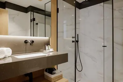 a bathroom with a sink and a shower at Porto River Soul Hotel in Vila Nova de Gaia