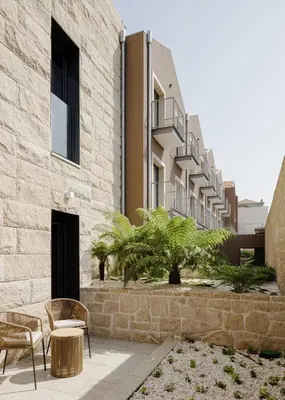 a rendering of a building with chairs and a patio at Porto River Soul Hotel in Vila Nova de Gaia
