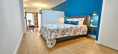 a bedroom with a bed and a blue wall at Serendipity in Porto