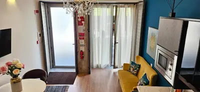 a living room with a yellow couch and a table at Serendipity in Porto