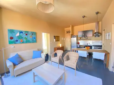 a living room with a couch and a table at Sunny Apartment in Porto