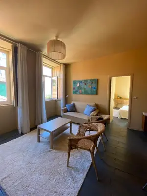 a living room with a couch and a table at Sunny Apartment in Porto