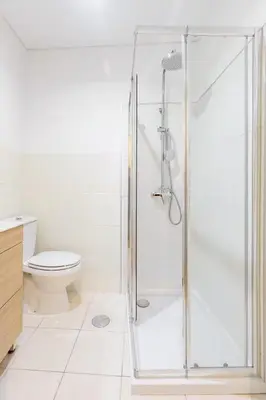 a glass shower in a bathroom with a toilet at Typical Oporto House in Porto