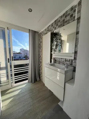a bathroom with a sink and a large window at Typical Oporto House in Porto
