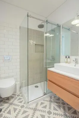a bathroom with a shower and a toilet and a sink at 58 House in Porto