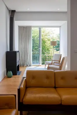 a living room with a couch and a large window at 58 House in Porto